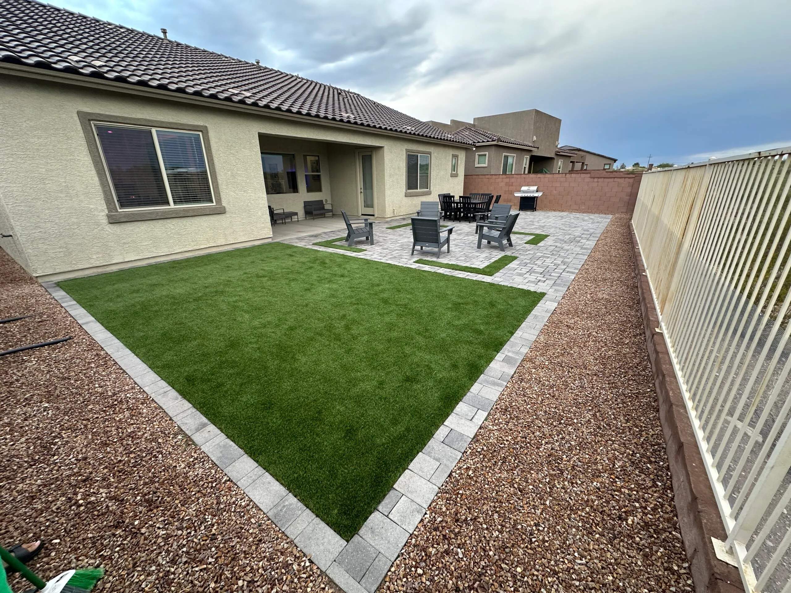 Paver patio with turf and desert landscaping in Tucson by Sorce Signature Outdoors