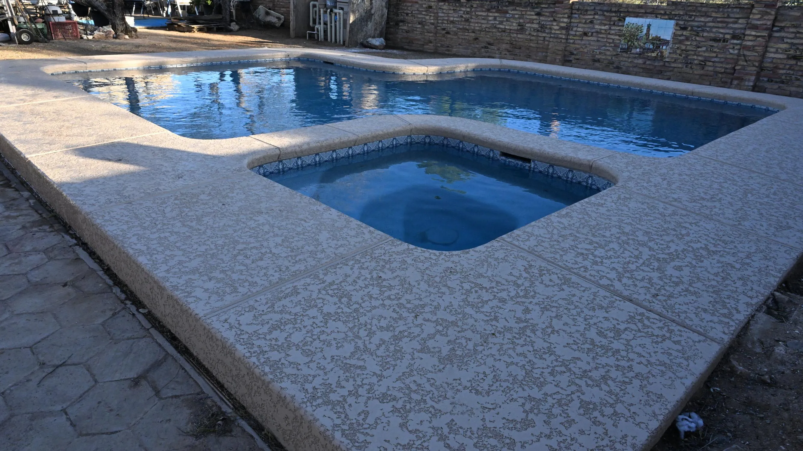 Pool with raised spa and stamped concrete deck in Tucson by Sorce Signature Outdoors